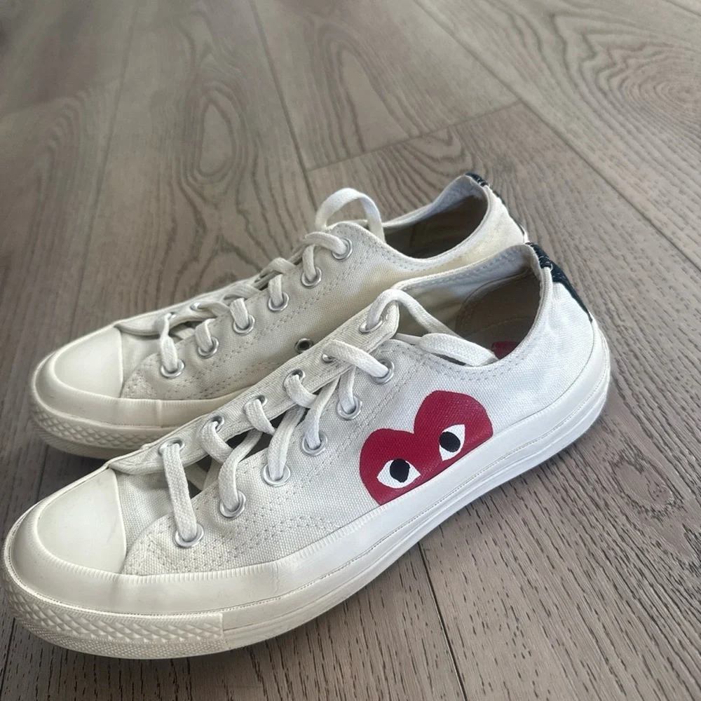 Comme Des Garçons Converse Women’s White Canvas Sneakers with Red Heart Graphic